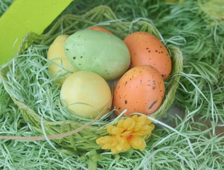 Colorful easter eggs in nest on straw