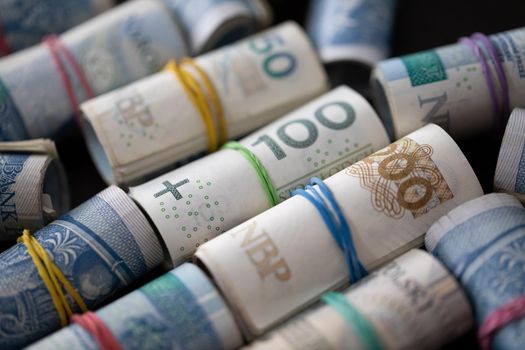 Rolled banknotes with the face value of two hundred zlotys and one hundred and fifty zlotys. Rolled and fastened with a rubber band.