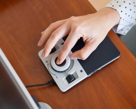 A woman uses a special magnification device for the visually impaired