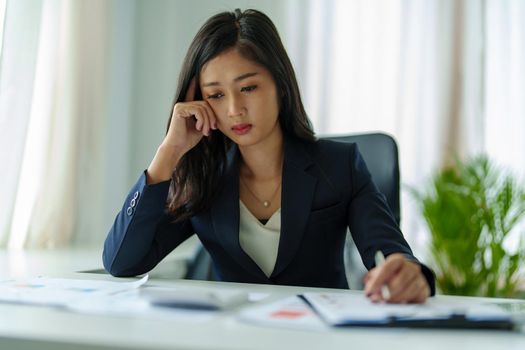 Concept Burnout Syndrome. Business Woman feels uncomfortable working. Which is caused by stress, accumulated from unsuccessful work And less resting body. Consult a specialist psychiatrist