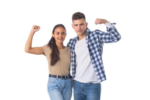 Portrait of a young attractive couple standing isolated over white background, flexing biceps, unity strength concept