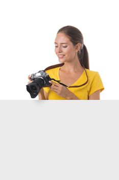 Young photographer girl with cameraand blank banner ad isolated white background
