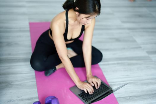 stress relief, muscle relaxation, breathing exercises, exercise, meditation, portrait of Young Asian woman relaxing her body from office work by practicing yoga by watching online tutorials