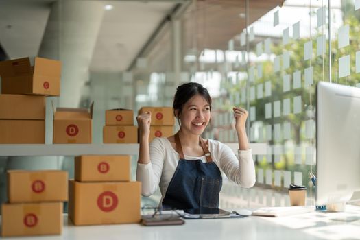 Starting Small business entrepreneur freelance, Portrait happy young woman working at home office, BOX, smartphone, laptop, online, marketing, packaging, delivery, b2b, SME, e-commerce concept.