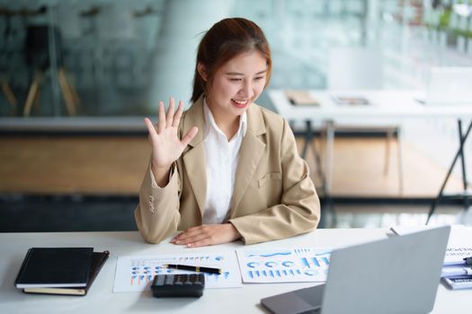 Data analysis, roadmap, marketing, accounting, auditing. Portrait of Asian businesswoman using computer in video conferencing, presenting marketing plan using statistical data sheet at work