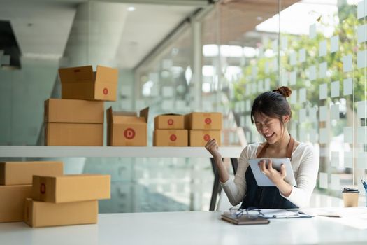 Starting Small business entrepreneur freelance, Portrait happy young woman working at home office, box online marketing, packaging, delivery, b2b, SME, e-commerce concept.