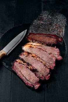 Fresh Brisket BBQ beef sliced for serving against a dark background. Generous accommodation for copy space. American style