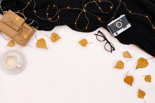 Autumn accessories for woman with yellow leaves and coffee with milk, top view. Flat lay. Copy space. Still life