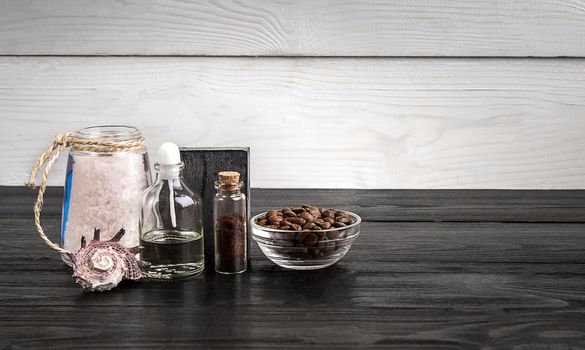 Composition of oil bottles and soap on black wooden background. Still life. Copy space. SPA set
