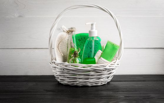 Green composition beauty treatment products in green colors: shampoo, soap, bath salt, oil. Various bath accessories. Items for the spa. Still life. Copy space