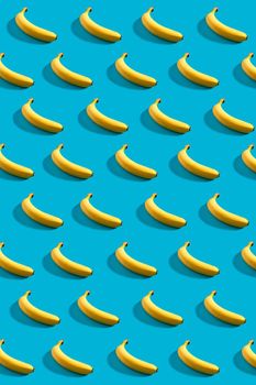 Colorful pattern of bananas on sky blue background. Still life