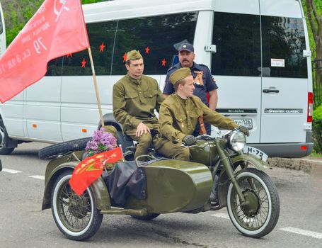 PYATIGORSK, RUSSIA - MAY 09, 2017: Men in uniform on a motorcycle M-72 with a cradle . The Victory Day celebration