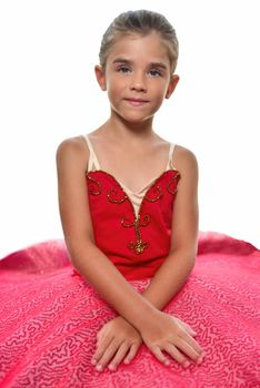 portrait of a beautiful little ballerina in a performance red dress dreaming to become professional ballet dancer. isolated on the white background