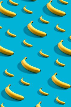 Colorful pattern of bananas on sky blue background. Still life