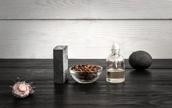 Composition of oil bottles and soap on black wooden background. Still life. Copy space. SPA set