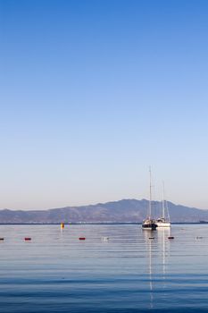 Blue sea, boats, mountains and islands on the Aegean coast. Summer vacation and coastal nature concept