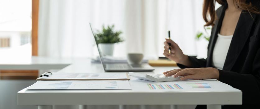 Close up view of bookkeeper or financial inspector hands making report, calculating or checking balance. Home finances, investment, economy, saving money or insurance concept.