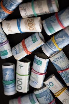 Rolled banknotes with the face value of two hundred zlotys and one hundred and fifty zlotys. Rolled and fastened with a rubber band.