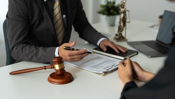 Businesswoman and female lawyer or judge consult having team meeting with client, Law and treaty of the law. Sign a contract business.