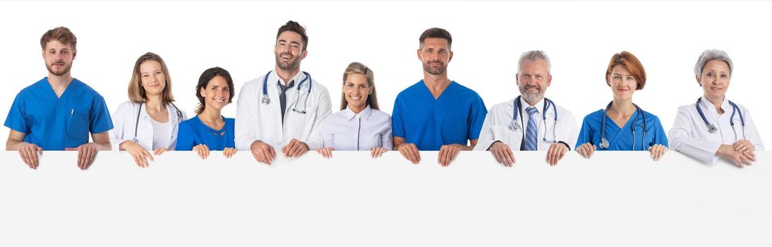 Group of doctors and nurses medical staff with blank banner isolated over a white background, copy space for text content