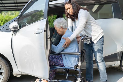 Asian senior or elderly old lady woman patient sitting on wheelchair prepare get to her car, healthy strong medical concept.