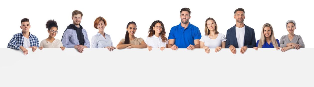 Large group of mixed race people holding together blank sign with copy space for text