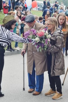 PYATIGORSK, RUSSIA - MAY 09, 2017: Carer and elderly man with a walking stick on Victory Day on a parade of 9 may