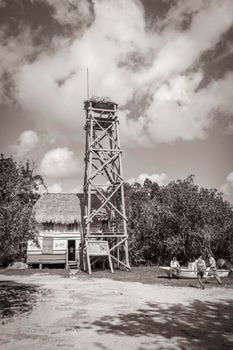 Muyil Mexico 02. February 2022 Old black and white picture of panorama view to the Muyil Lagoon in the tropical jungle nature forest with boats people watch tower in Sian Ka'an National park Mexico.