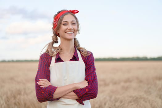 Woman farmer standing farmland smiling Female agronomist specialist farming agribusiness Happy positive caucasian worker agricultural field Pretty girl dressed red checkered shirt and bandana