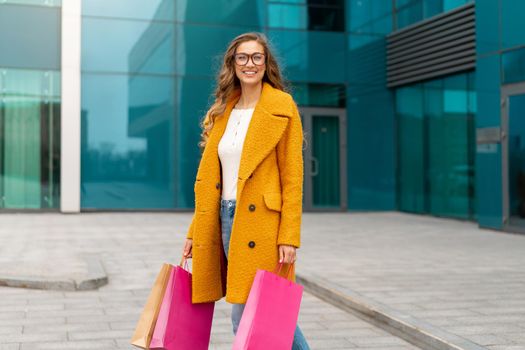 Business Woman With Shopping Bags Dressed Yellow Coat Walking Outdoors Corporative Building Background Caucasian Female Business Person Near Office Building Stylish Businesswoman Season Sale