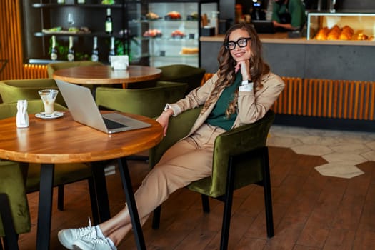Business Woman Restaurant Owner Use Laptop Dressed Elegant Pantsuit Sitting Table In Restaurant With Bar Counter Background Caucasian Female Business Person Indoor full length