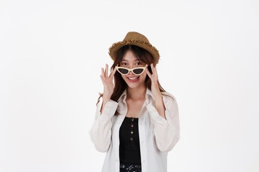 Image of happy young woman wear sunglasses and hat isolated over white background. Travel concept