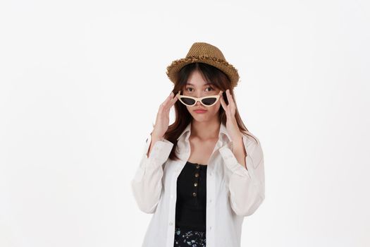 Image of happy young woman wear sunglasses and hat isolated over white background. Travel concept