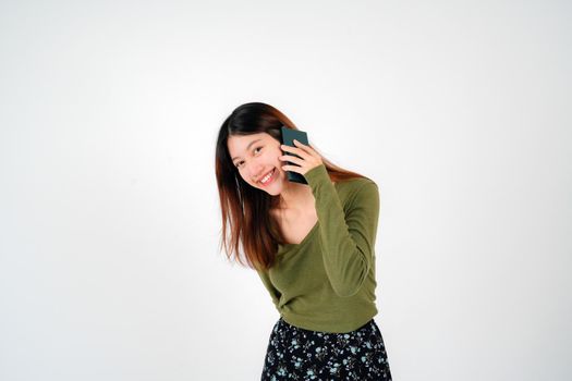 Portrait of young asian woman is calling on mobile phone, Attractive of Asian Woman is Talking on Her Smartphone and Smiling While Communicating on white background