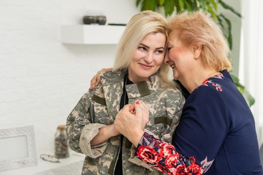 military woman and elderly mother at home.