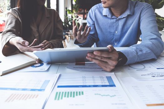 Fund managers team consultation and discuss about analysis Investment stock market by digital tablet