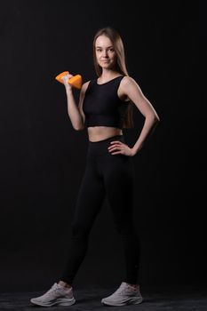 Beautiful black background a on . Maiden orange dumbbells with orange two gym, for shape fitness from fit and weight diet, muscle loss. Active beginner joy, arms young overweight doing