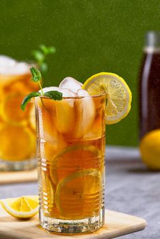Iced tea. Traditional iced tea with lemon and ice in tall glasses.