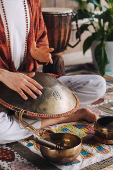 Close-up of a man's hand playing a modern musical instrument, the orion reed drum.