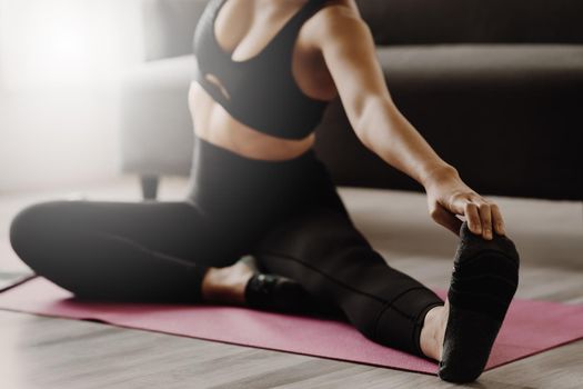 Young woman practicing yoga follow teacher at home. Calmness and relax concept