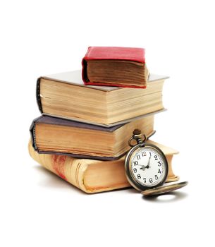 Education concept. Stack of books near pocket watch on white background