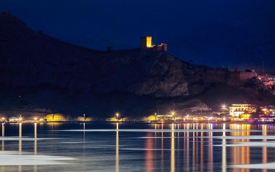 Night view on Genoese Fortress from sea side in Sudak, Crimea