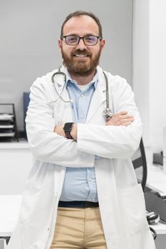 Portrait of confident doctor crossing hands and smiling at camera. High quality photography.
