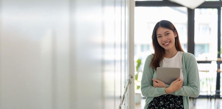 Portrait of young happy attractive asian student smiling and looking at camera. Asian woman in self future education or personalized learning concept