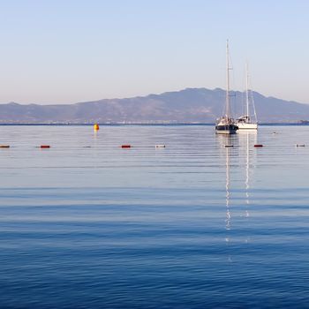 Blue sea, boats, mountains and islands on the Aegean coast. Summer vacation and coastal nature concept