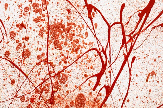 Red painted splashes, drops and trail as a blood on white background. Horror, crime, mysticism concept. Backdrop for halloween. Bloods splatter