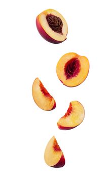 Set of smooth-skinned, sweet nectarines with kernels and without them isolated on white background with copy space for text or images. Variety of peach. Side view. Close-up shot.