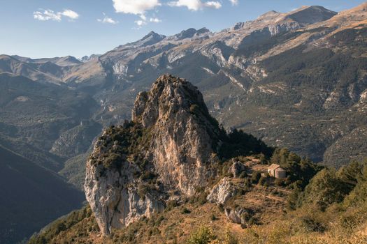 Beautiful landscape in the Pyrenees showing a small church in a rocky mountain in a trekking route called Ermitas de Tella in Huesca Spain