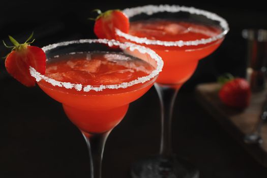 Fresh homemade refreshing strawberry cocktail margarita in glasses on the table.