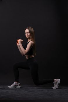 Beautiful on black background with orange maiden dumbbells a . Orange two gym, for shape body from woman and sport diet, happy plus. Chubby physical joy, portrait young overweight doing